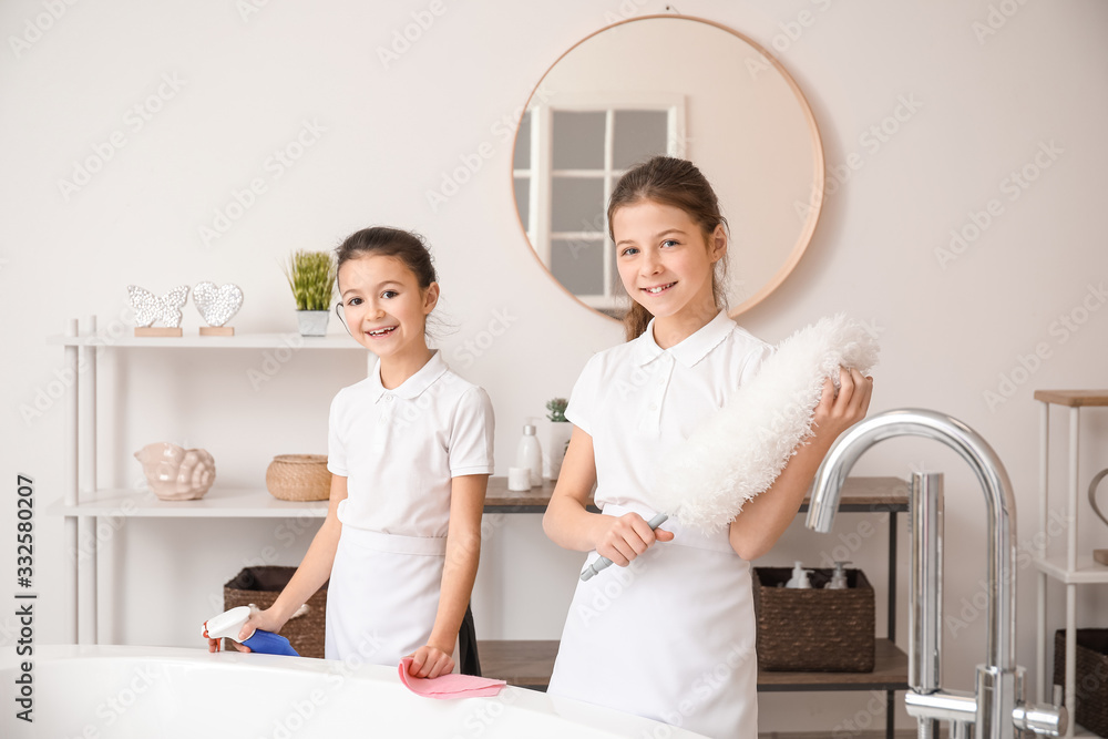 Fototapeta premium Cute little chambermaids cleaning bathroom