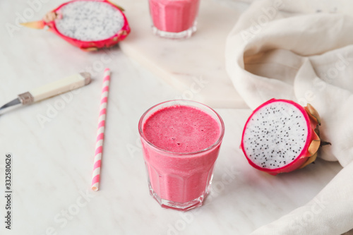 Glass of dragon fruit smoothie on white background