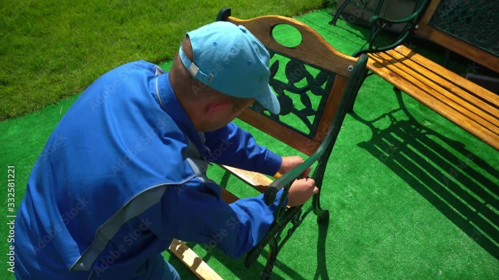 custom made wallpaper toronto digitalCarpenter man in blue work wear joining wooden retro bench in house yard