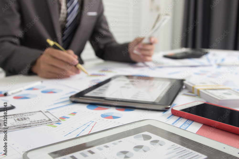Business man using calculator and holding money for calculate tax in office Business man using calculator and holding money for calculate tax in office