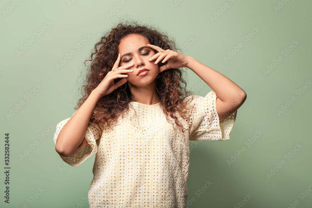 Beautiful African-American woman on color background Beautiful African-American woman on color background