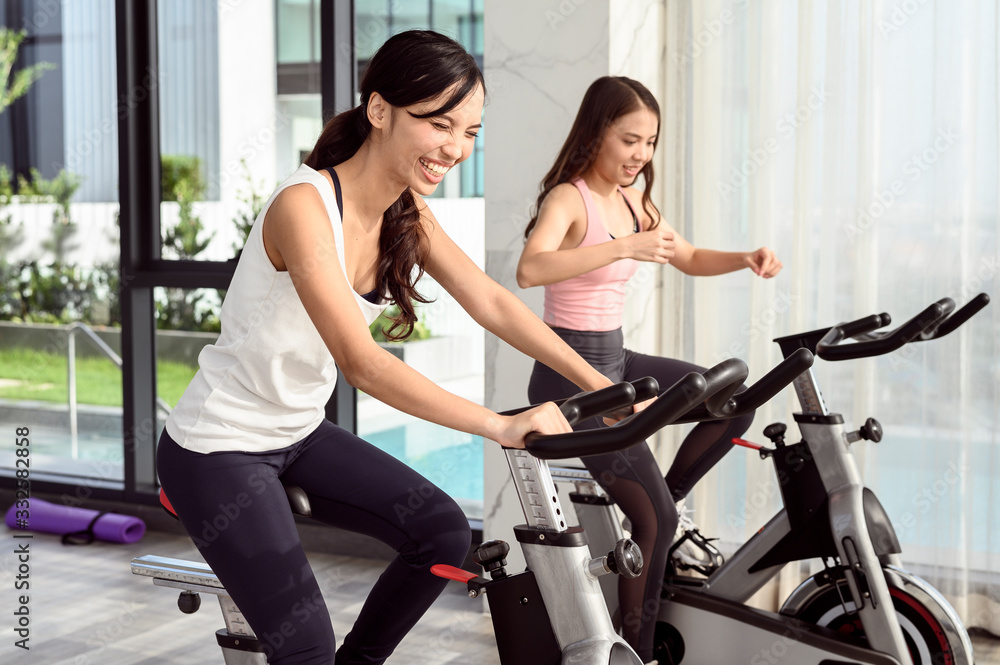 Two smiling young woman workout in the gym Two smiling young woman workout in the gym