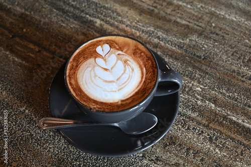 Latte coffee on dark wooden table