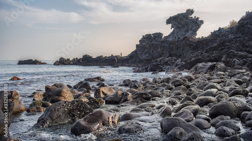 The scenery of the Yongduam Rock (Dragon Head Rock) in Jeju island, South Korea.