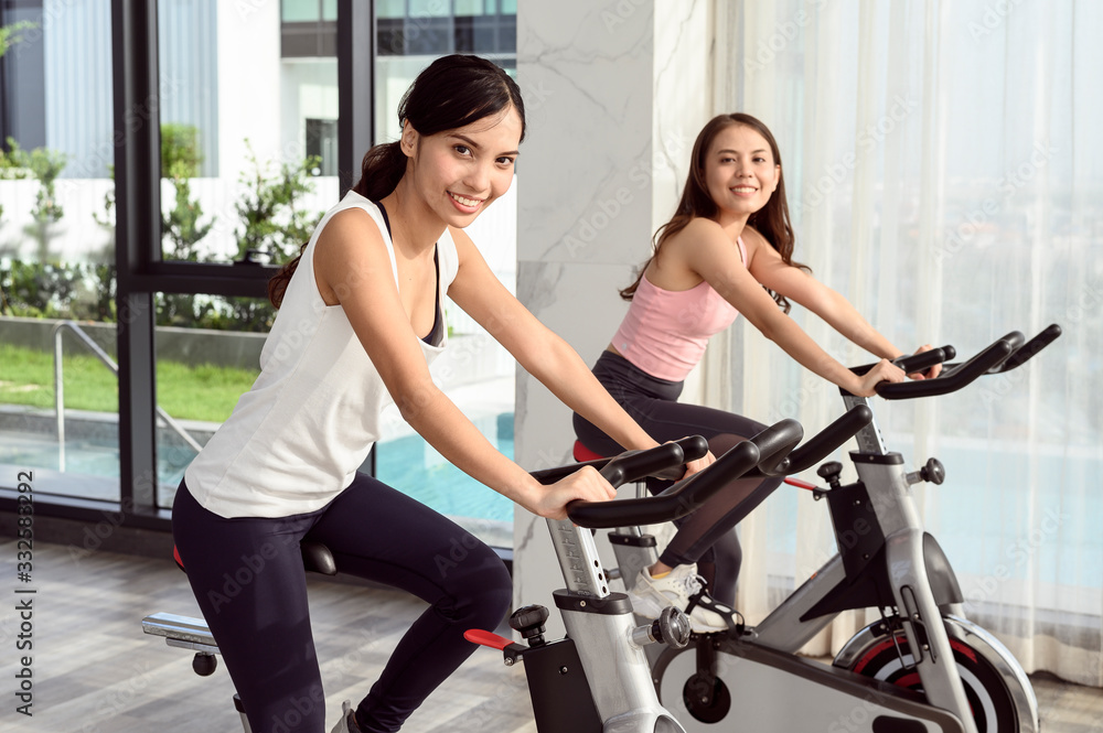 Two smiling young woman workout in the gym Two smiling young woman workout in the gym