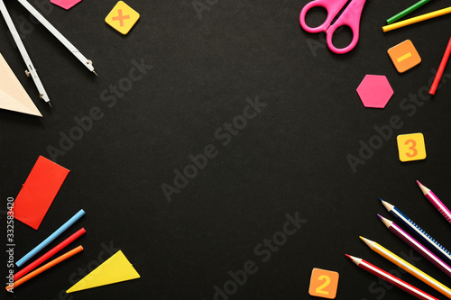 Back to school background: school supplies on black chalk board with copy space