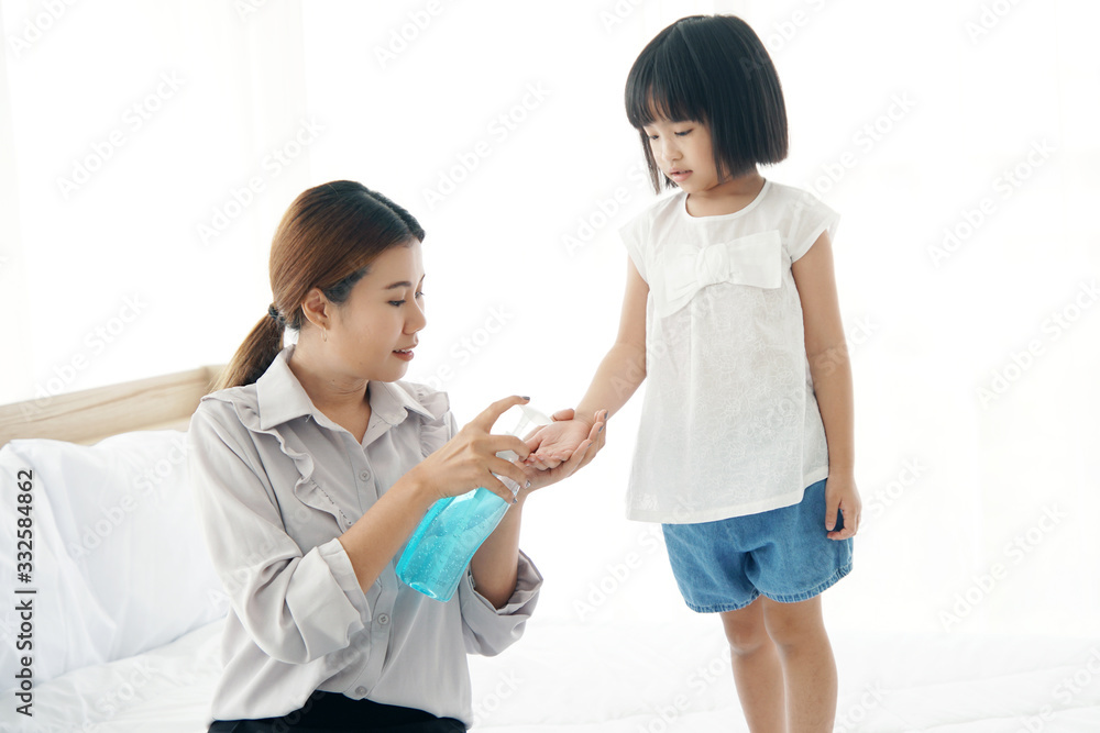 Young mother washs her baby's hand by using a hand wash sanitizer gel. In the epidemic virus situation Young mother washs her baby's hand by using a hand wash sanitizer gel. In the epidemic virus situation
