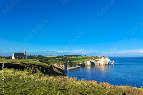 Beautiful cliffs Aval of Etretat, rocks and natural arch landmark of famous coastline, sea landscape of Normandy, France, Europe