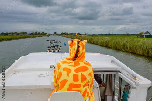 Fotografia Family vacation, summer holiday travel on barge boat in canal, man in funny kigu