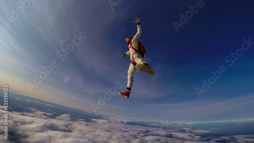Clean. Clear sky under your feet. A professional skydives. The flow of the wind.