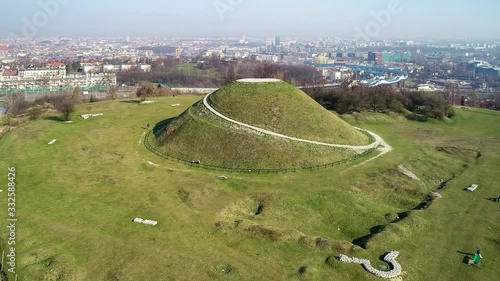Krakus Mound in Krakow, Poland. Krakus was legendary founder of the town. The origin of the mound, probably early medieval kurgan, is not known. Old quarry in front. City panorama in the background