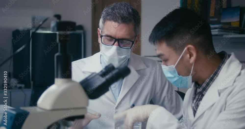 Professor and student discussing in laboratory Professor and student discussing in laboratory
