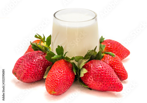 Fresh strawberries with milk on a white background