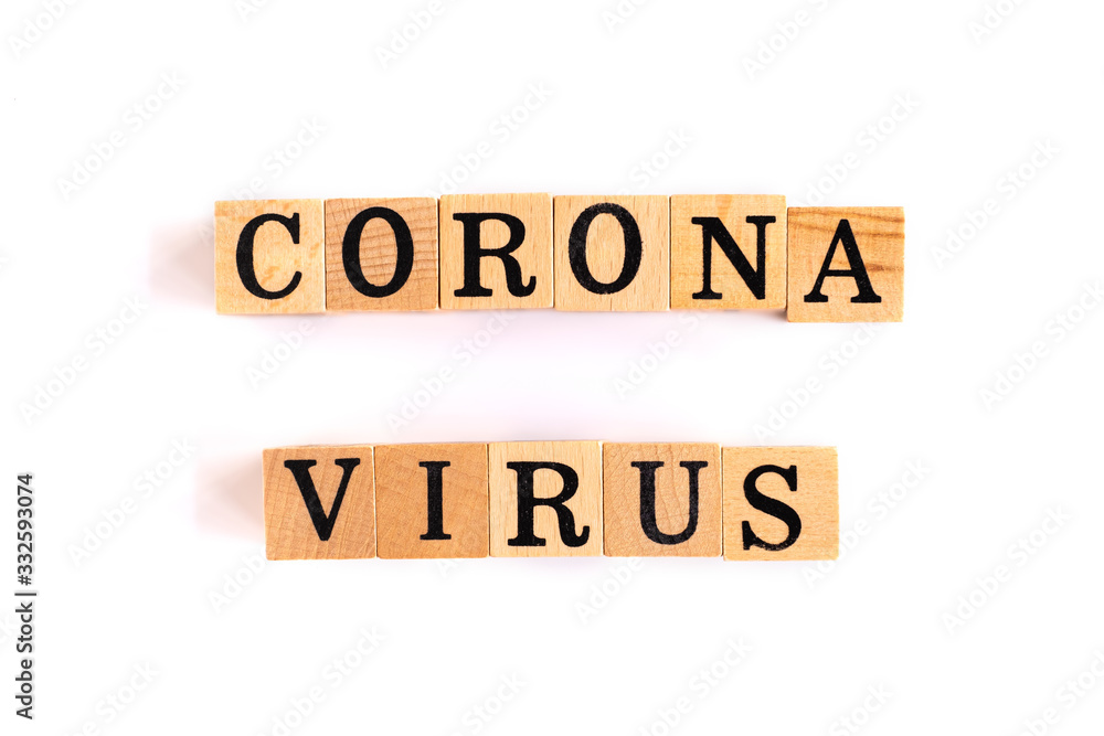The letter corona Virus is on a wooden block on a white background.