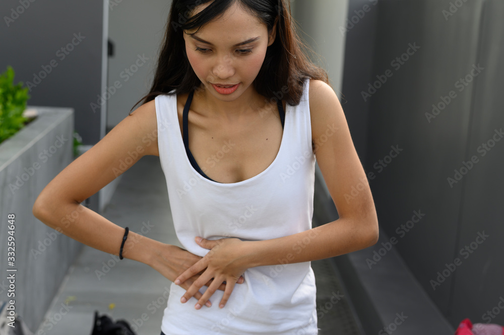 Stomach pain. Worried mature woman touching belly Stomach pain. Worried mature woman touching belly