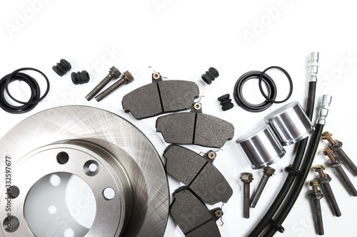Bild auf Leinwand brake parts on white: brake pads, disc, brake hose, guides, cylinders