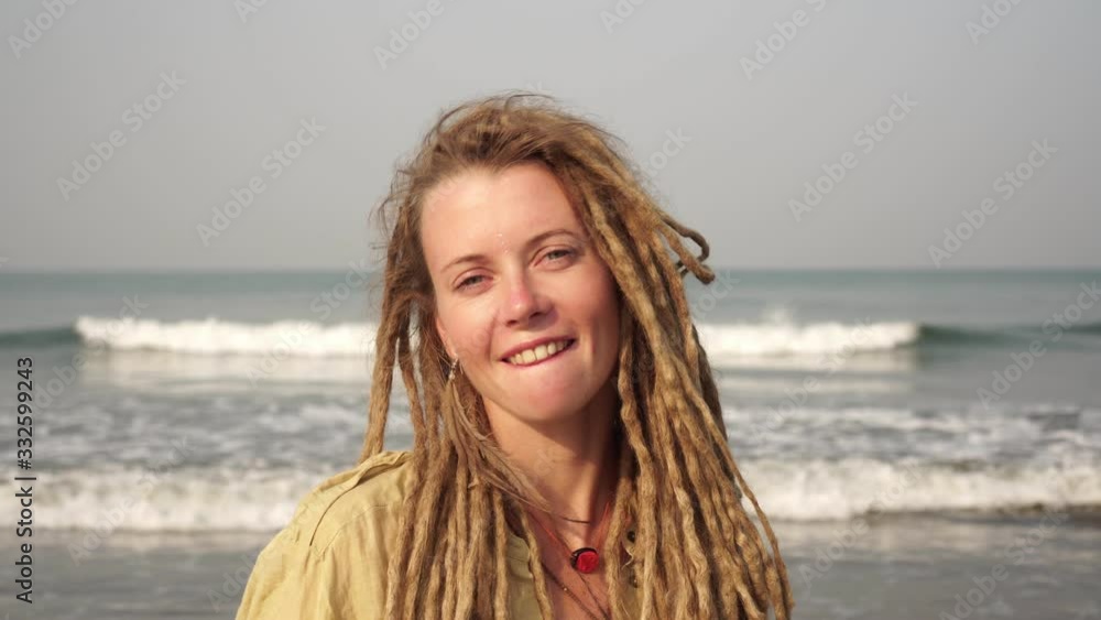 Portrait of a young beautiful woman with dreadlocks on a background of the sea. Portrait of a young beautiful woman with dreadlocks on a background of the sea.