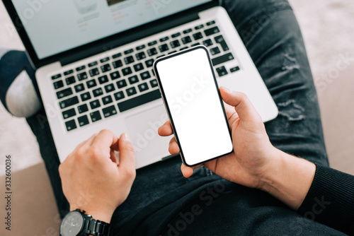 Man's right hand using mobile with blank screen. Mockup image white screen.