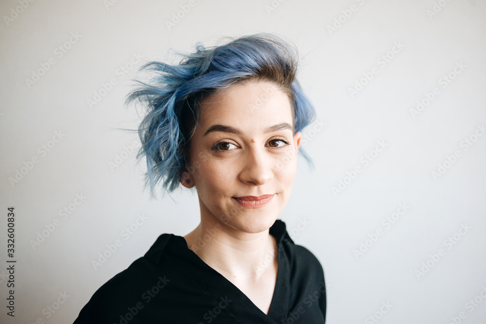 A beautiful girl with blue hair is smiling. A beautiful girl with blue hair is smiling.