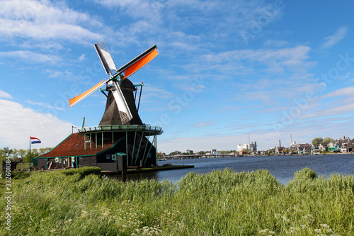 View of traditional Dutch windmills along the canal in spring at the Zaanse Schans  Zaandam  Netherlands