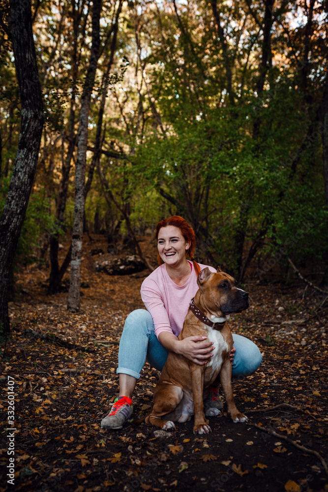 redhaired woman with her dog have fun on the walking redhaired woman with her dog have fun on the walking