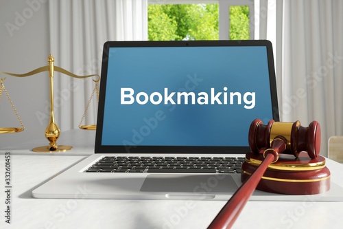 Bookmaking – Law, Judgment, Web. Laptop in the office with term on the screen. Hammer, Libra, Lawyer.