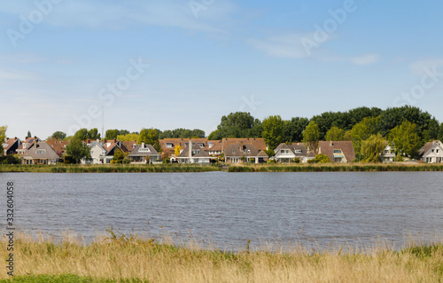 View of traditional Dutch houses along the canal in spring at the Zaanse Schans, Zaandam, Netherlands
