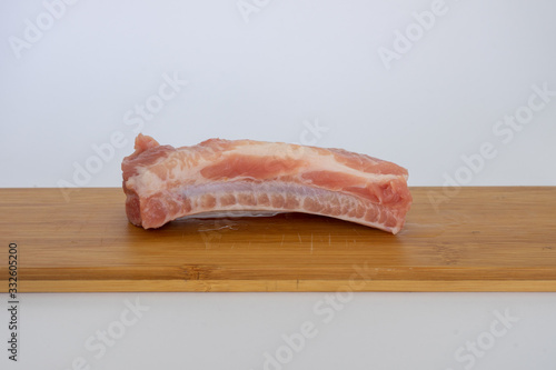 Pork ribs. An ingredient widely used in Canarian gastronomy. The ribs are on a wooden board.