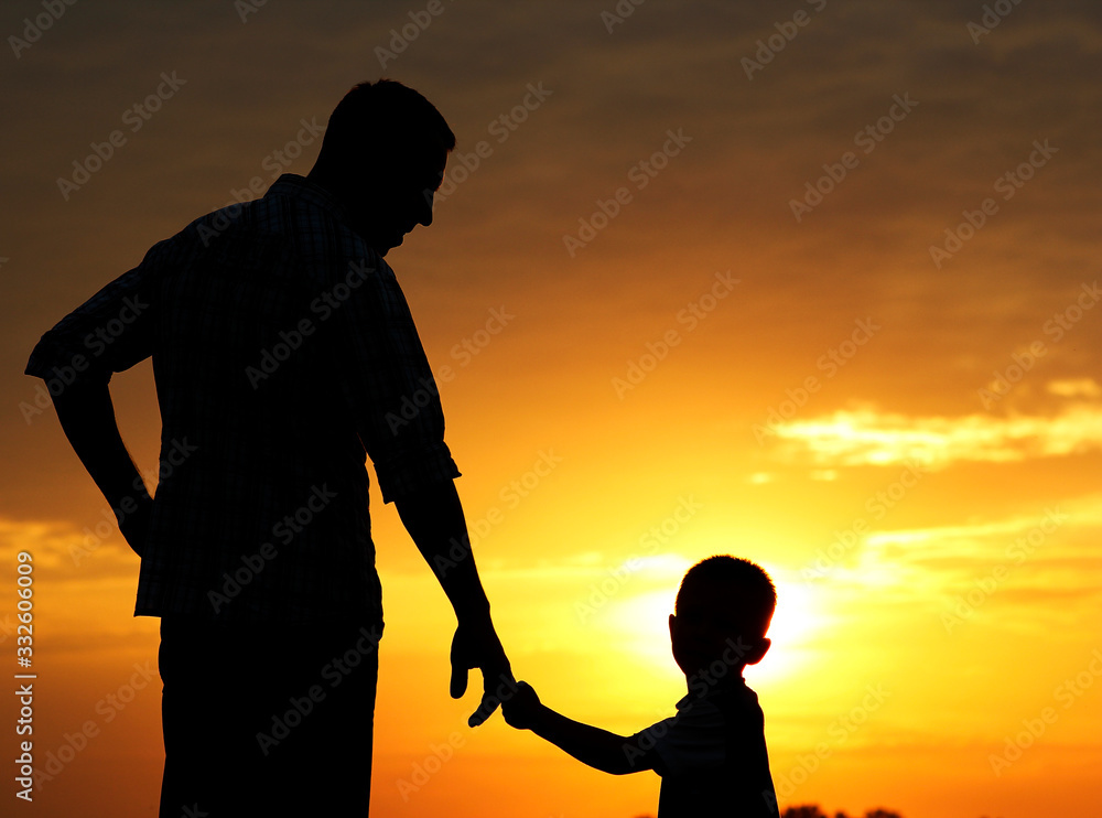silhouette of father and son  on sunset