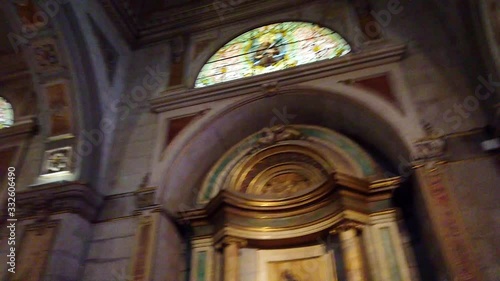 Beautiful interior shot of ceiling, stained glass and arches in church