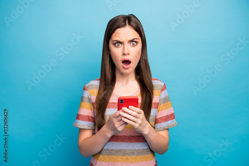 Close-up portrait of her she nice lovely worried sullen grumpy irritated mad angry girl using device browsing fake news fail failure isolated over bright vivid shine vibrant blue color background photo