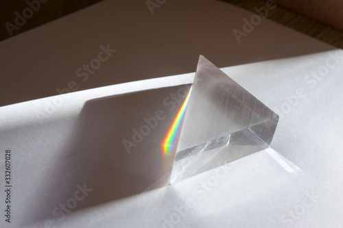 Rainbow spectrum of colors caused by breaking and dispersion of sunlight in a glass prism