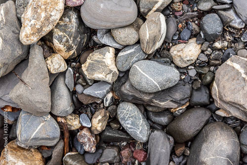 stones and rocks in a water stream in the forest. Pebbles close up