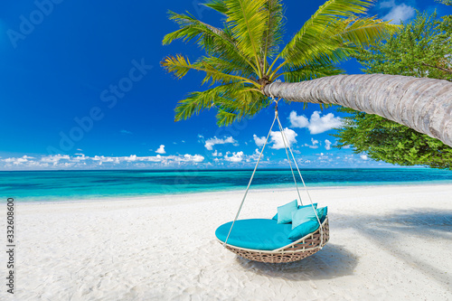 Tropical beach background as summer landscape with beach swing or hammock and white sand and calm sea for beach banner. Perfect beach scene vacation and summer holiday concept, luxury beach landscape