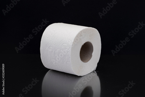 Roll of toilet paper with side texture on black background