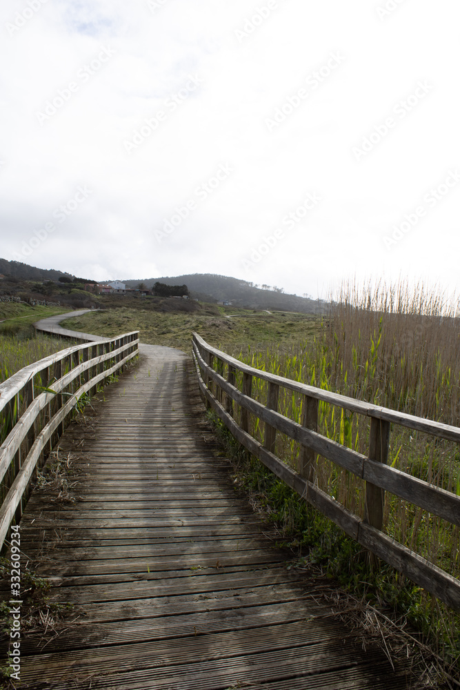 Dunes of Corrubedo, beach and walk, Galicia, Spain. Beautiful wooden walk path in dune beach in the north of Spain. 