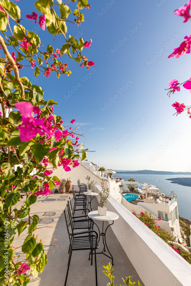 Obraz premium Beautiful terrace with flowers, sea view. Santorini island, Greece.