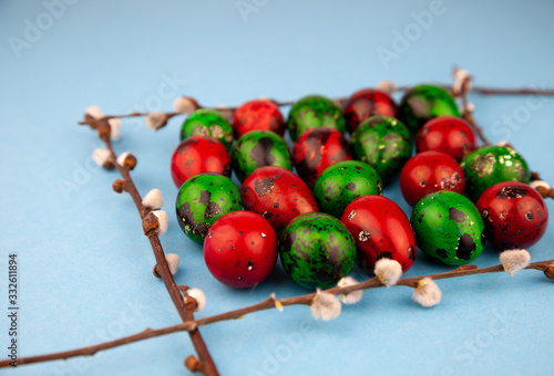 Easter eggs background. Green and red eggs. Colorful Quail colored eggs. Place for text. Different little painted egg set. Dietary nutrition. 