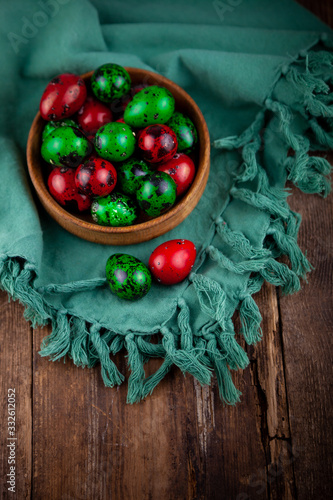 Easter eggs background. Green and red eggs. Colorful Quail colored eggs. Place for text. Different little painted egg set. Dietary nutrition. 