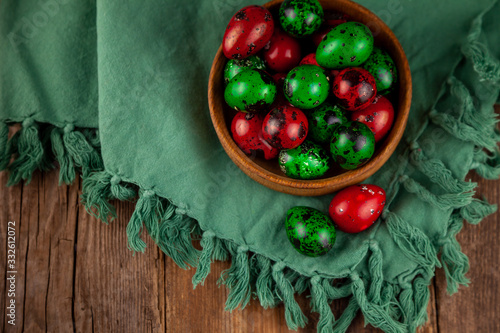 Easter eggs background. Green and red eggs. Colorful Quail colored eggs. Place for text. Different little painted egg set. Dietary nutrition. 
