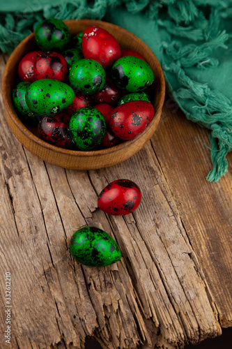 Easter eggs background. Green and red eggs. Colorful Quail colored eggs. Place for text. Different little painted egg set. Dietary nutrition. 