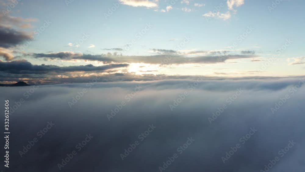 AERIAL Sun Setting Flying Over Low White Fluffy Cloud Cover AERIAL Sun Setting Flying Over Low White Fluffy Cloud Cover