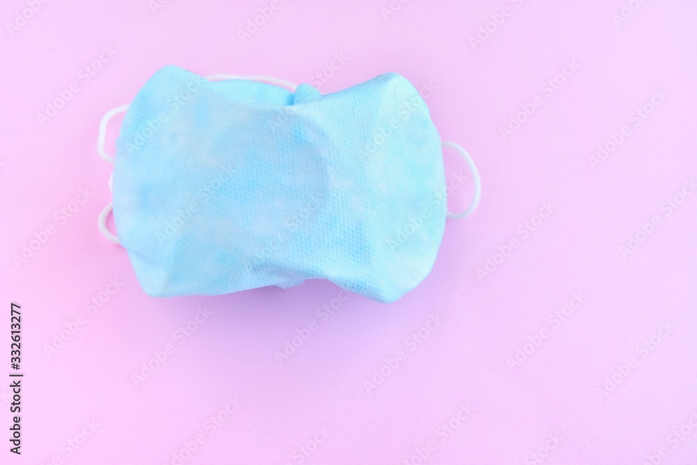 Fototapeta premium Sterile protection face mask against coronavirus ffp2. Increased potential. high demand. face mask against covid-19, virus, flu coronavirus. breathing medical mask on pink background 