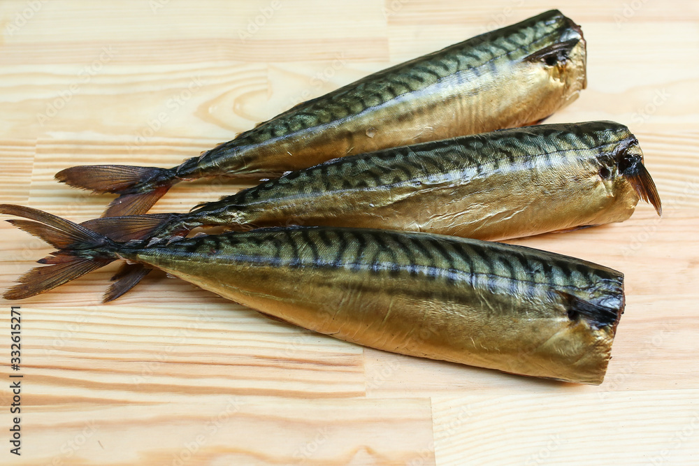 salted, smoked and dried fish, beer snacks, tasty fish on a wooden board salted, smoked and dried fish, beer snacks, tasty fish on a wooden board