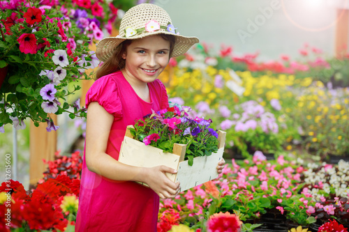 Backyard outdoor portrait of young girl gardener with plants delivery. © Gorilla