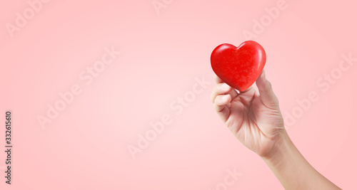 Hands holding a red heart. and donation concepts