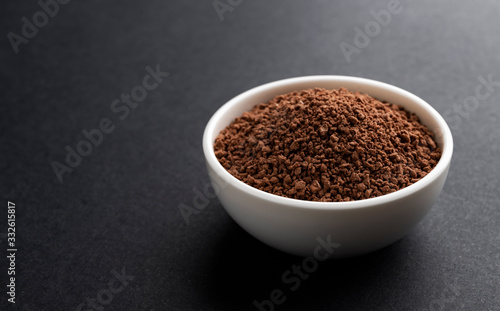 Pile of cocoa powder on black background