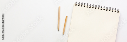 White table at home. Open empty sketchbook, wooden pencils.Mockup. Creative desk. Panorama