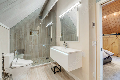 Amamzing modern new bathroom interior with wheat beige color venetian plaster, white wood vaulted ceiling, mural of bubbles and ice, natyral tone tiles, large free standing tub.  photo