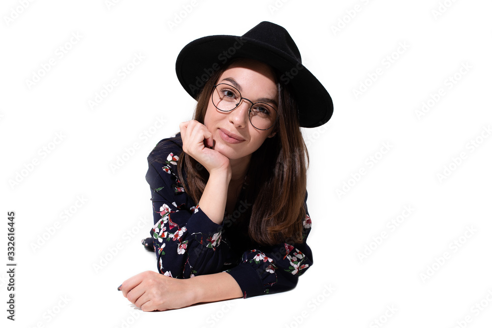 Portrait of a beautiful girl in a hat posing for the camera Portrait of a beautiful girl in a hat posing for the camera